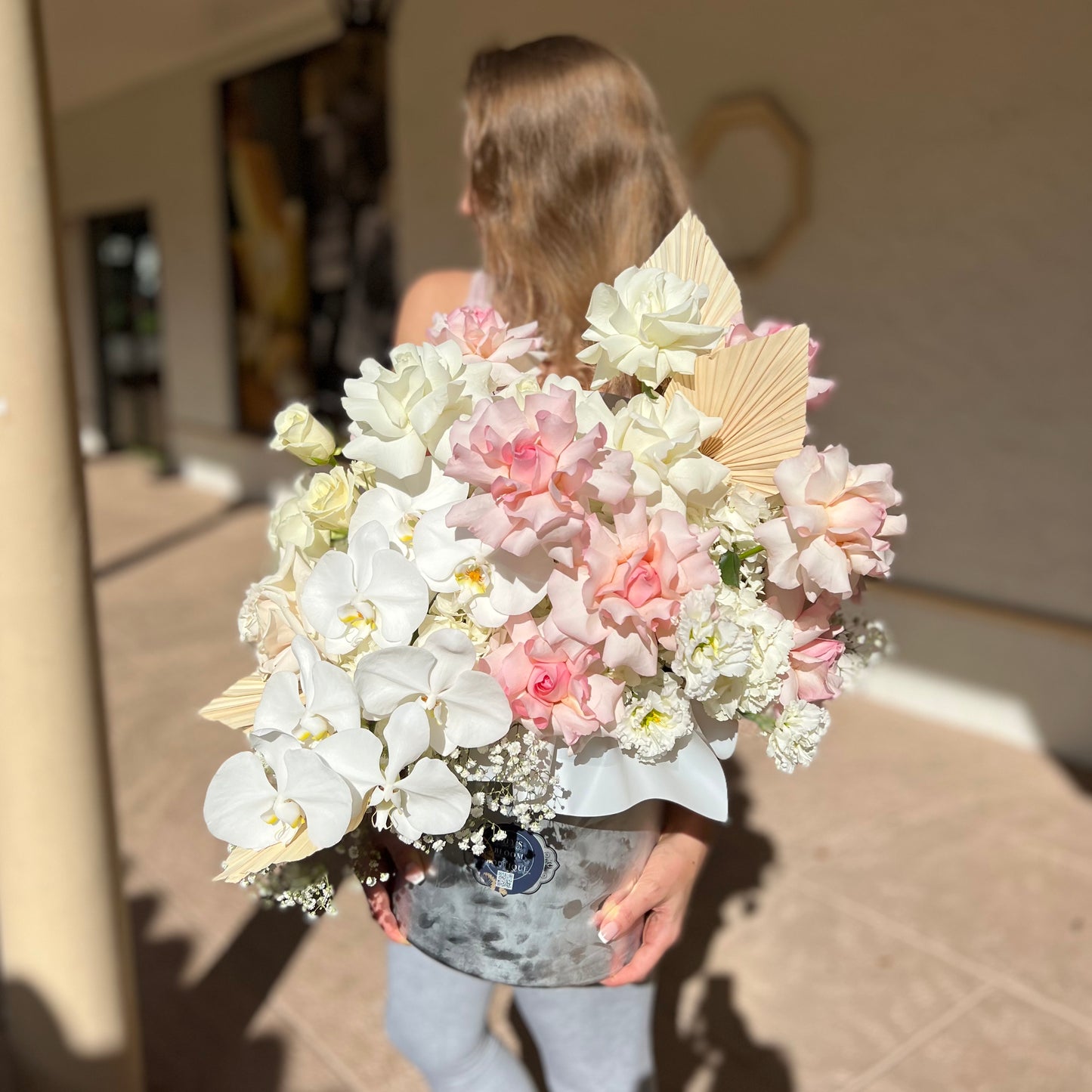 A Bunch Of Happy Thoughts flower box held by a woman
