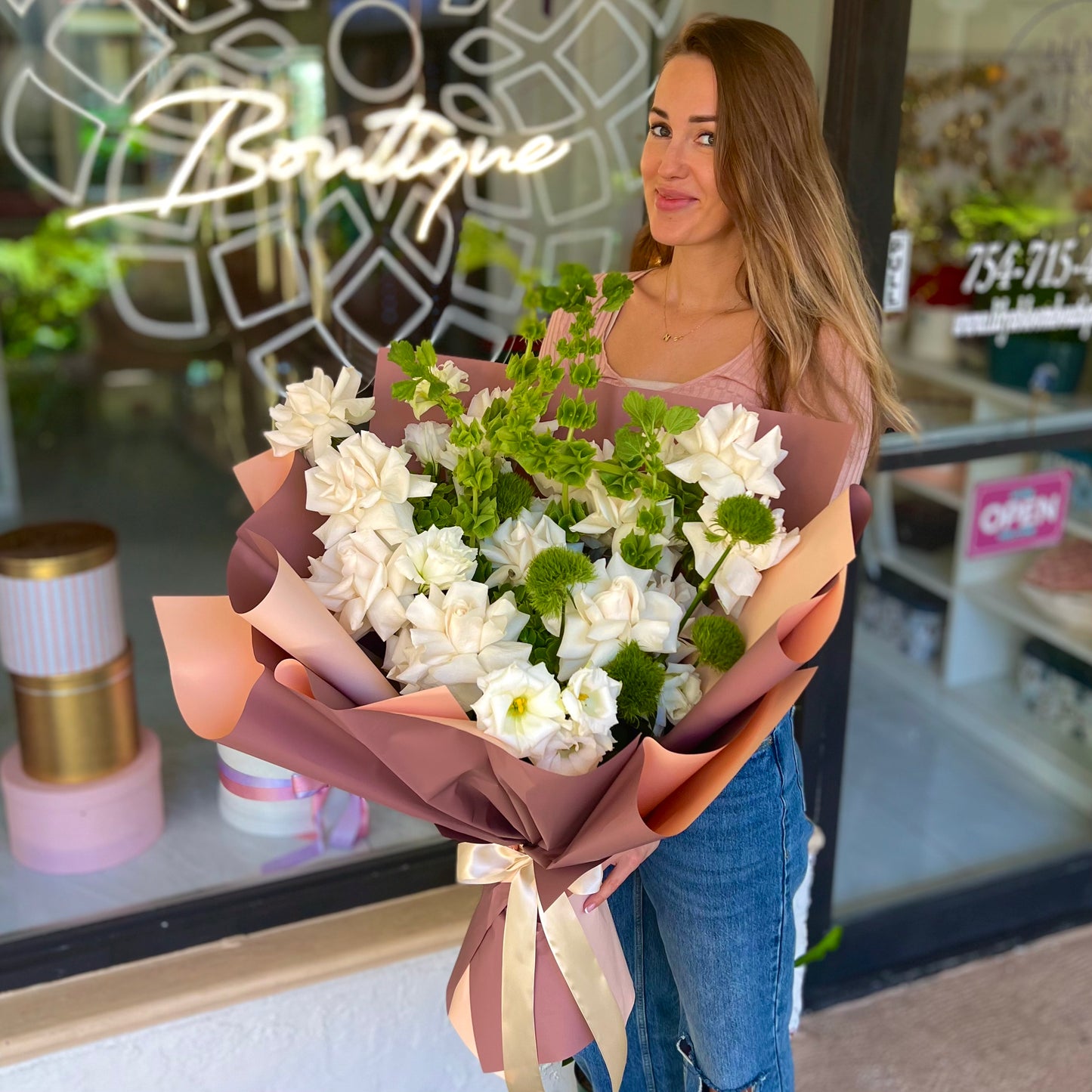 Beautiful full color white flower bouquet in pink tissue paper