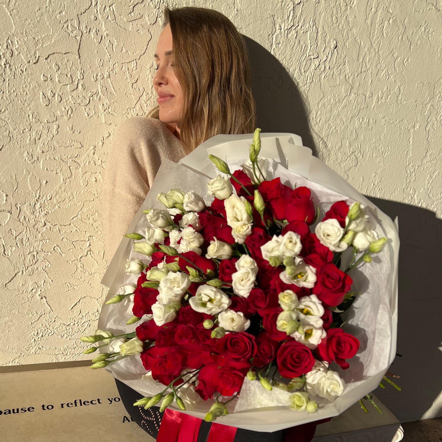A beautiful woman with a gorgeous bouquet of flowers