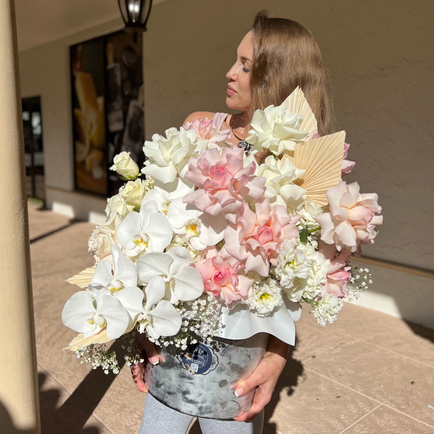 White roses with orchids, baby breath, lisianthus, hydrangeas and pink opened petals roses.