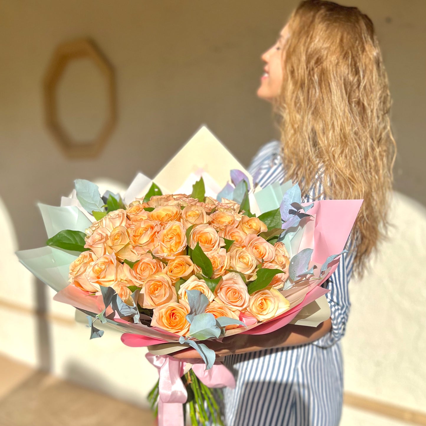 sun beating down on women face holding flowers