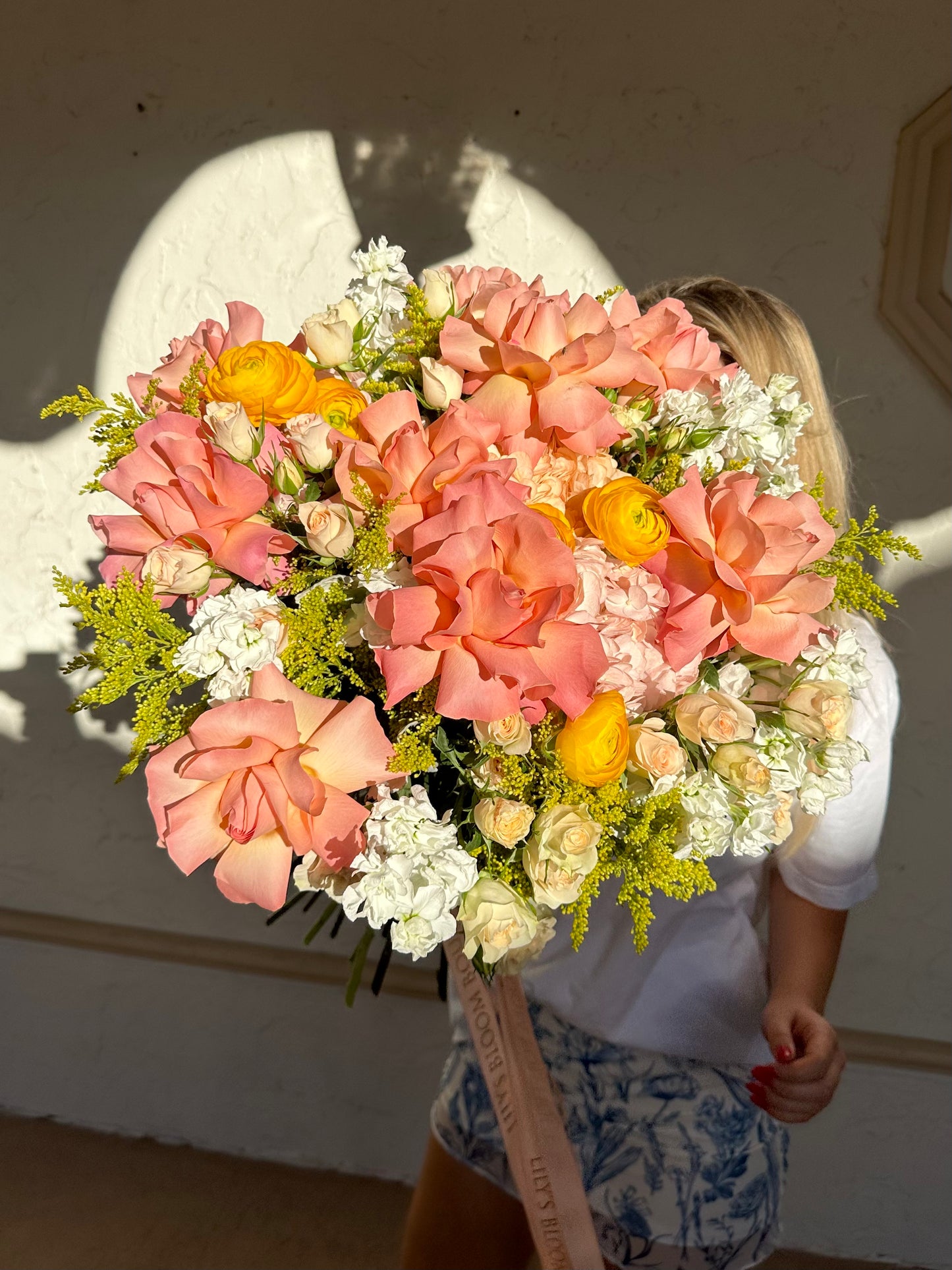 a bouquet of roses, ranunculus, hydrangeas and stocks