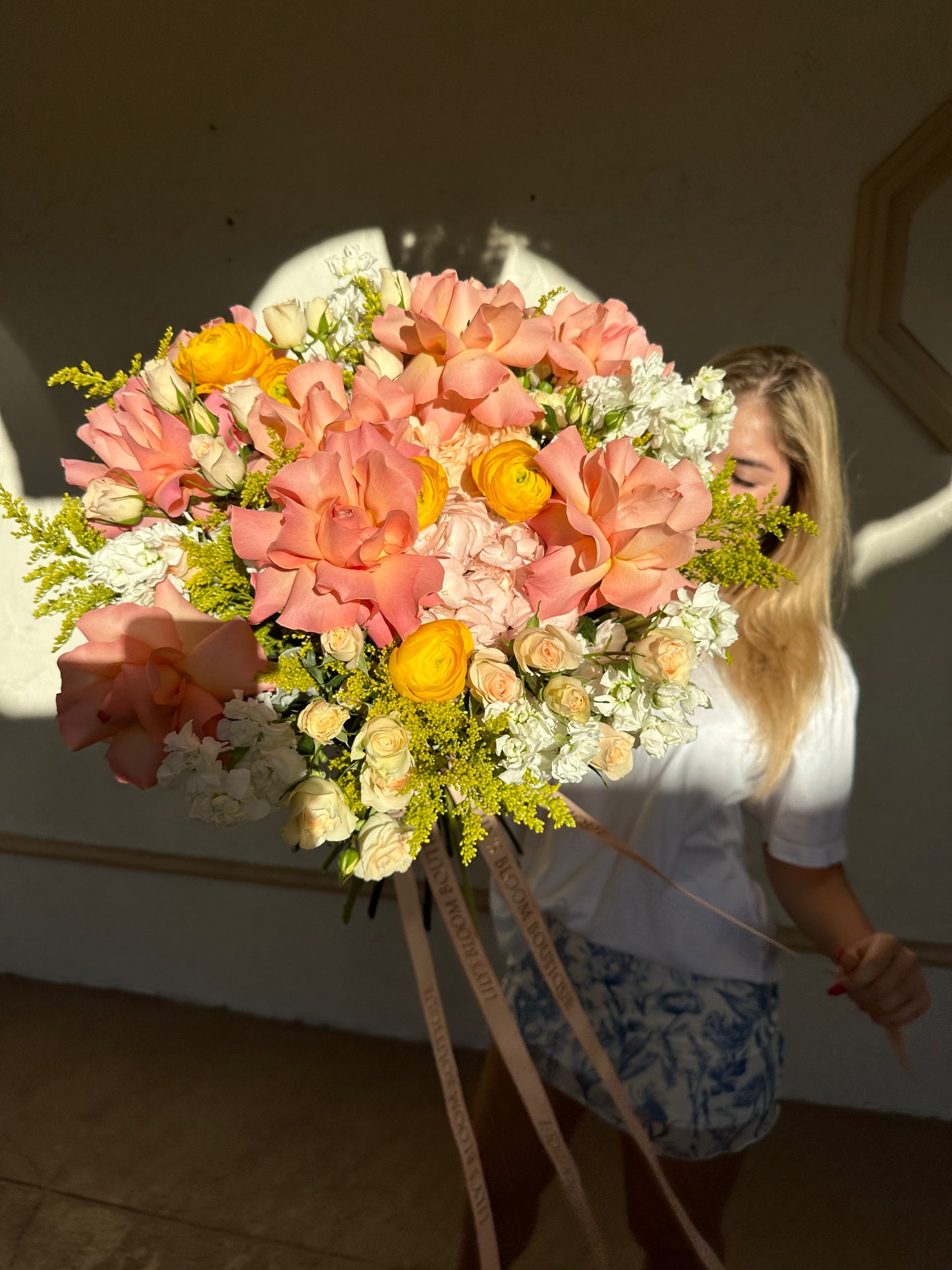 peach, yellow, white flowers in a gorgeous bouquet with ribbon