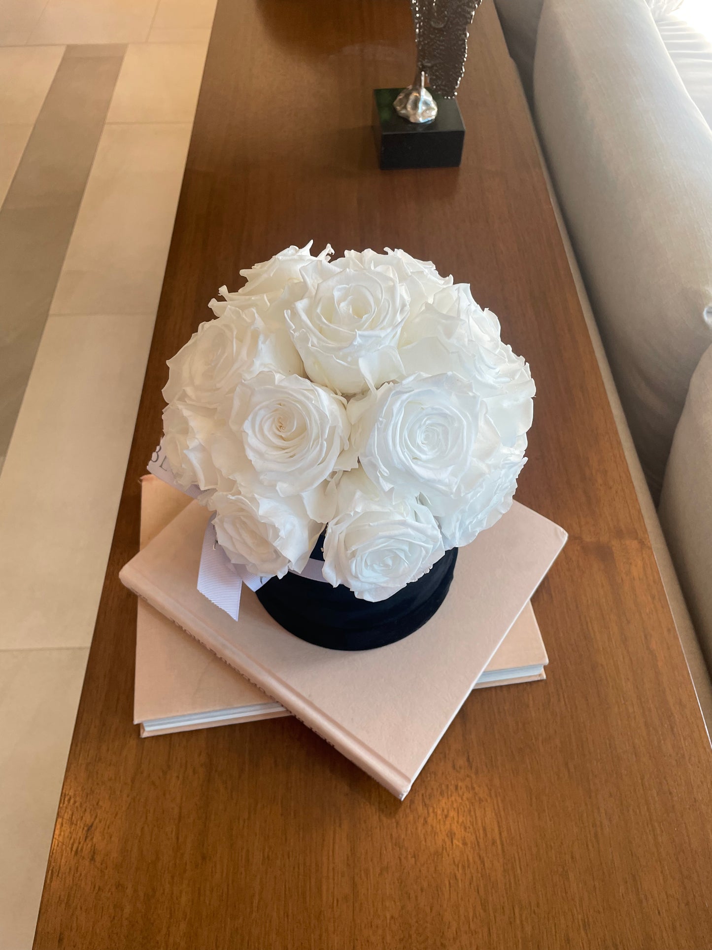 White preserved roses in black box