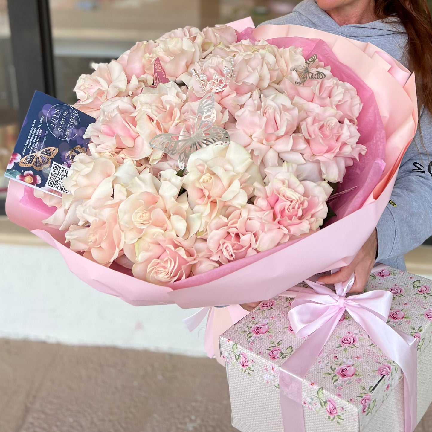 A woman holding gorgeous pink roses bouquet