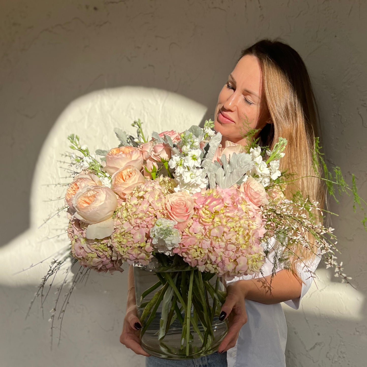 A beautiful woman holding stunning light color bouquet