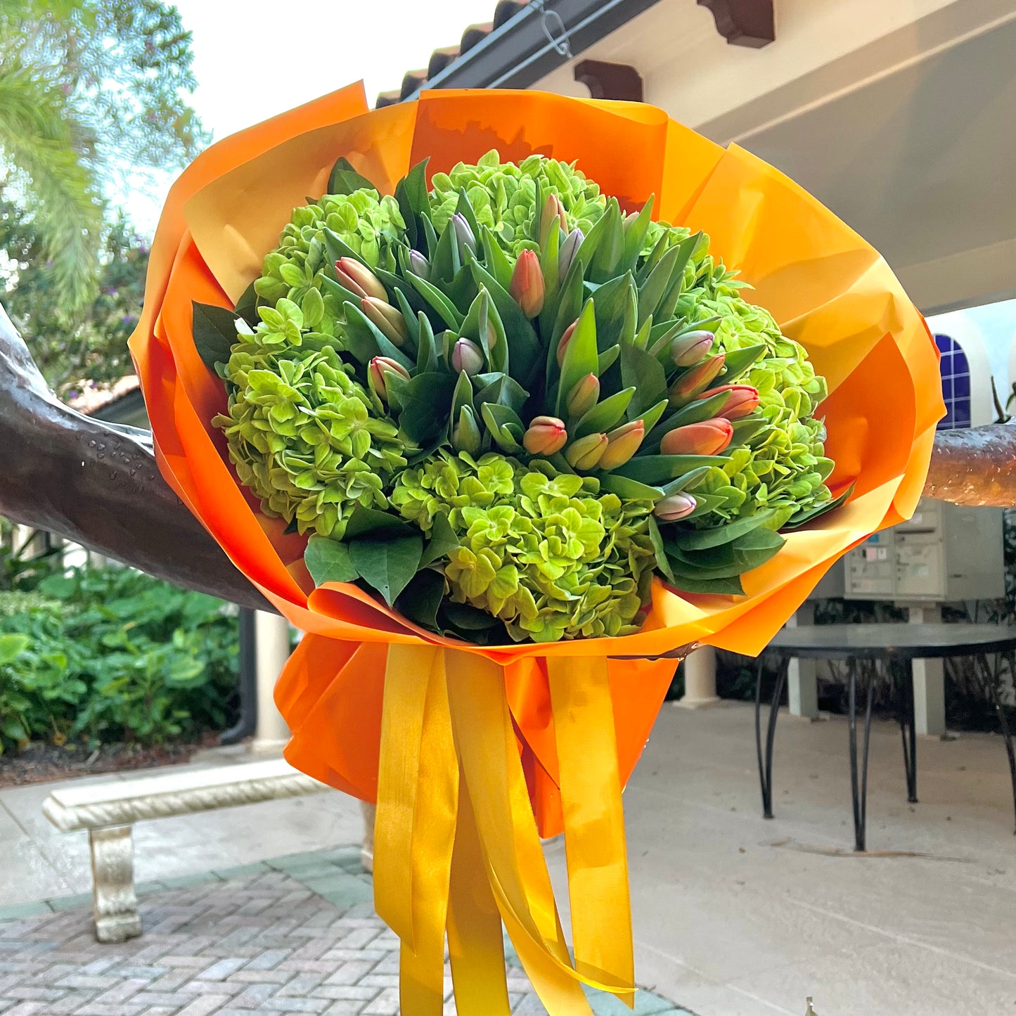 Tulips and hydrangeas in orange wrapping paper