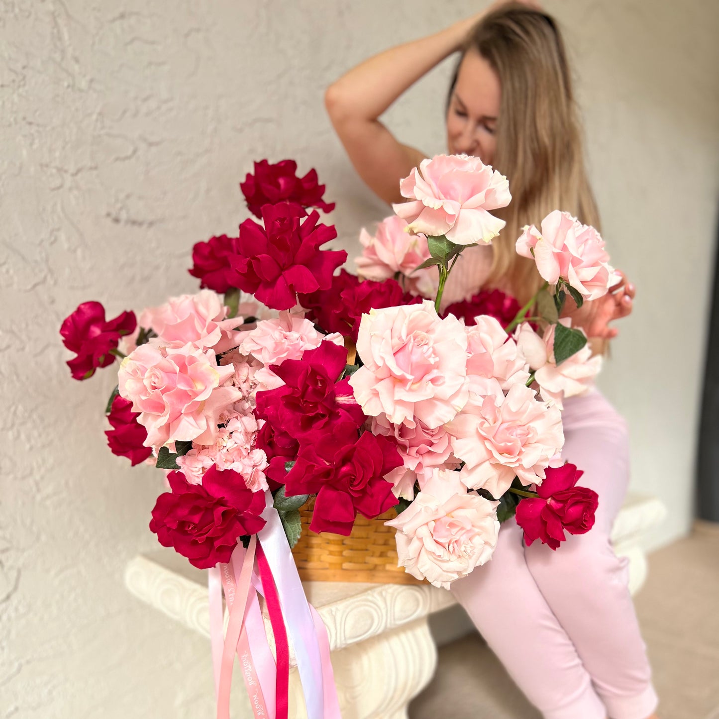 Beautiful bouquet of roses in front of a stunning woman