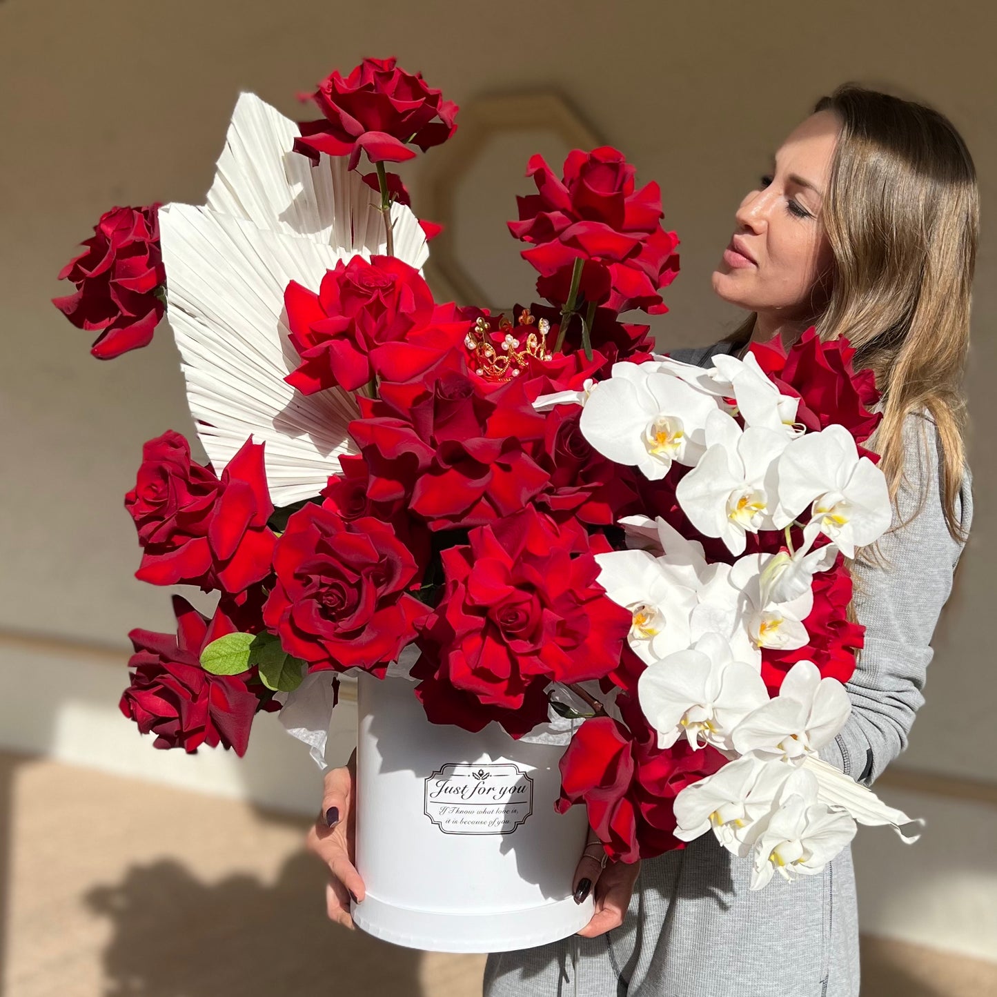 A beautiful woman holding the gorgeous Rafaello box