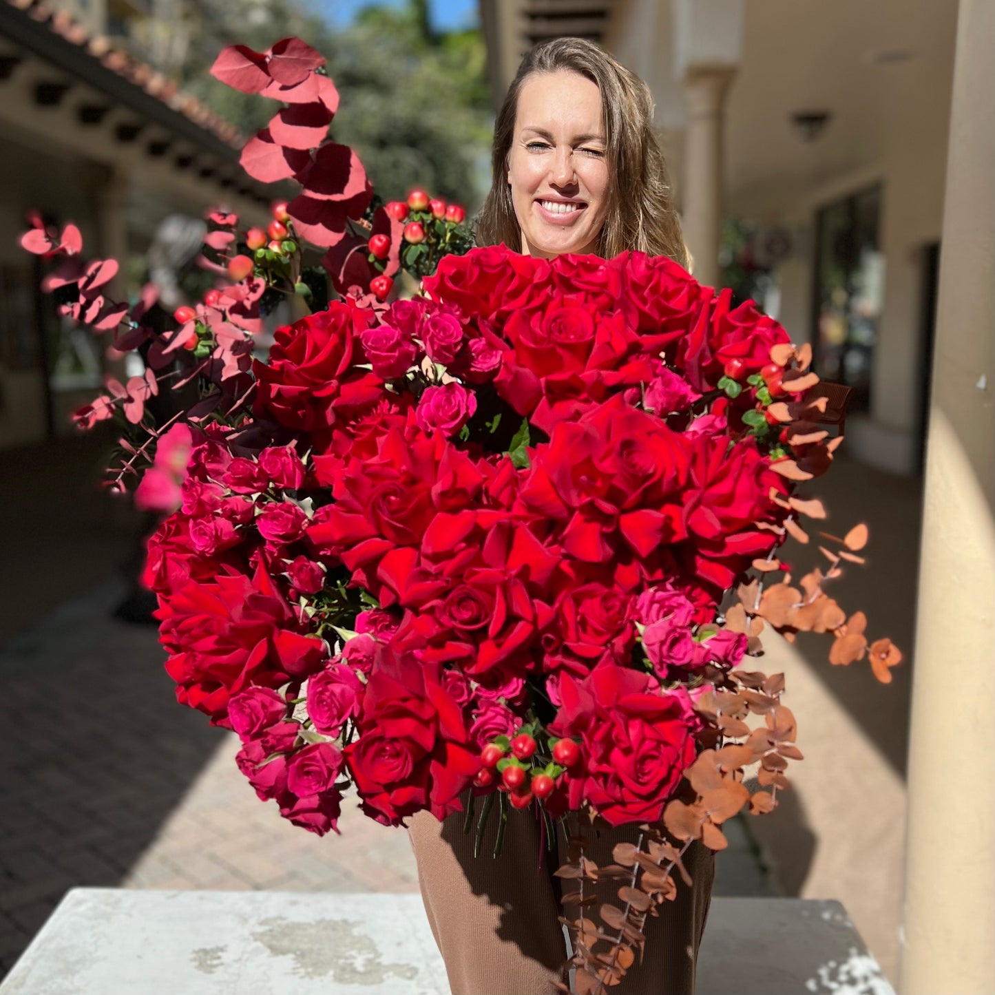 Photo of a woman with Esmeralda Red Roses Bouquet