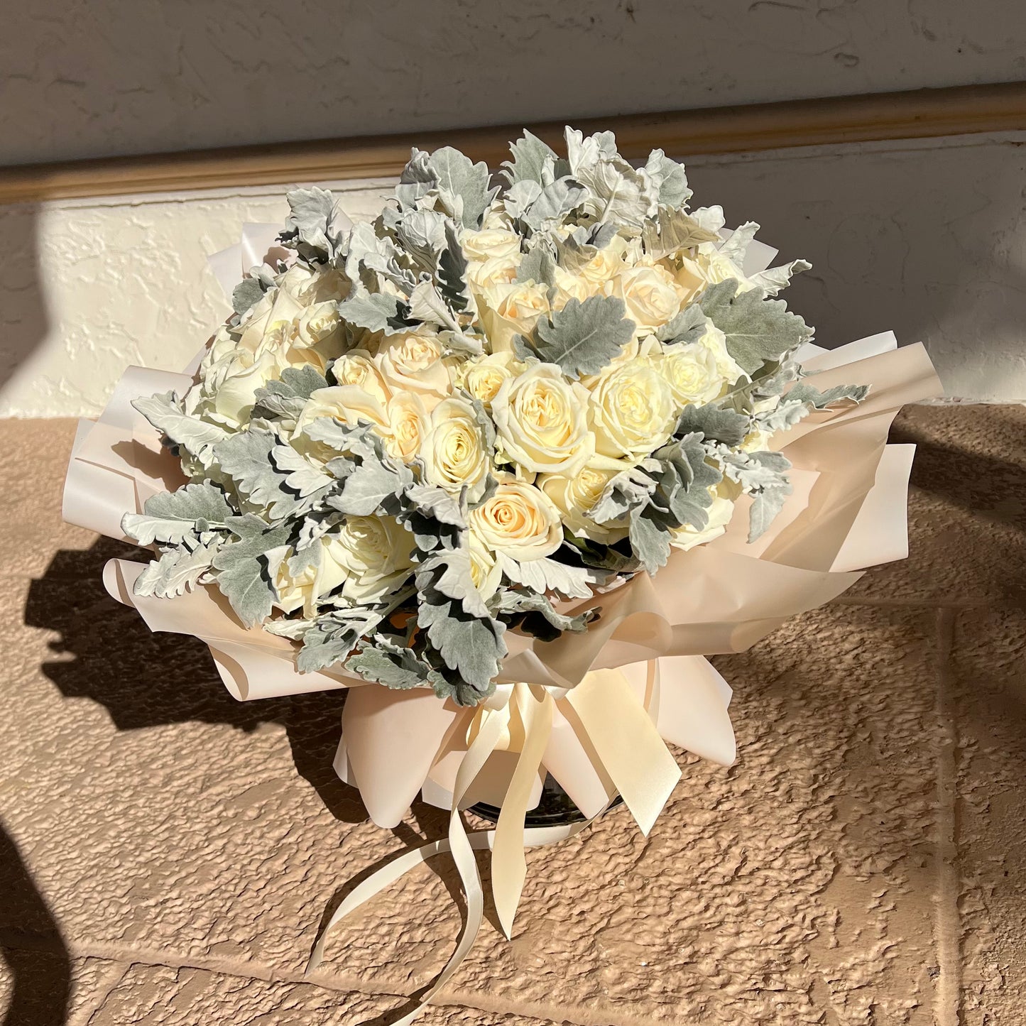 White roses and Dusty Miller on the floor