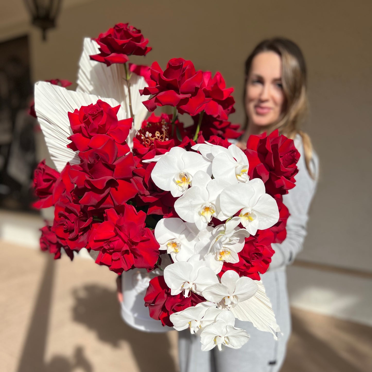 A bouquet of red roses and white orchids