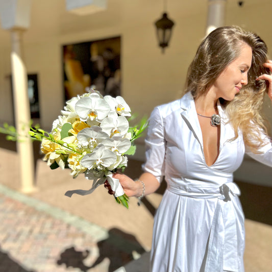A woman holding Bridal Bouquet with Orchids